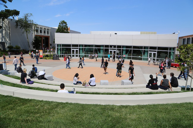 open space conrete quad with students walking through