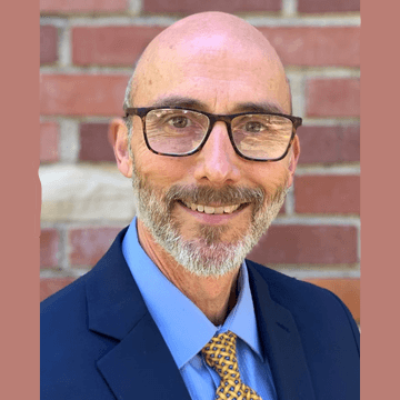 Professional Headshot of Kevin Bontenbal in a blue suit and yellow and brown checked tie