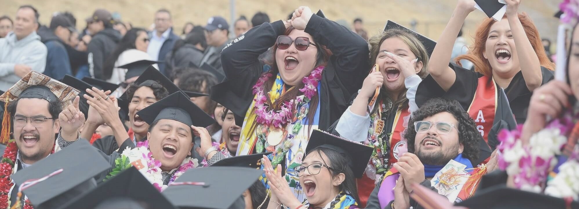 three students at a scholarship awards ceremony holding their awards and smiling