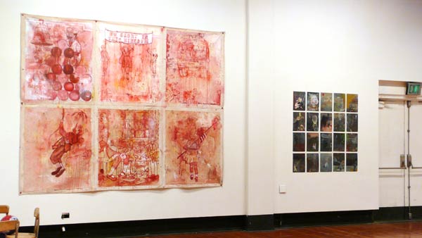 wall art featuring red painted caricature scenes that look bloody