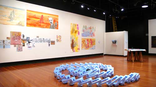 art installation of a spiral of large tumbled dominoes