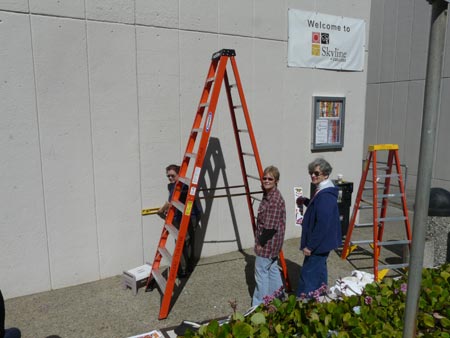 empty concrete wall with ladder before mural