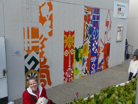 the mural is beginning to take shape, with a few columns painted in orange and blue