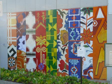 the finished mural featuring colorful textile designs from a range of countries across the world