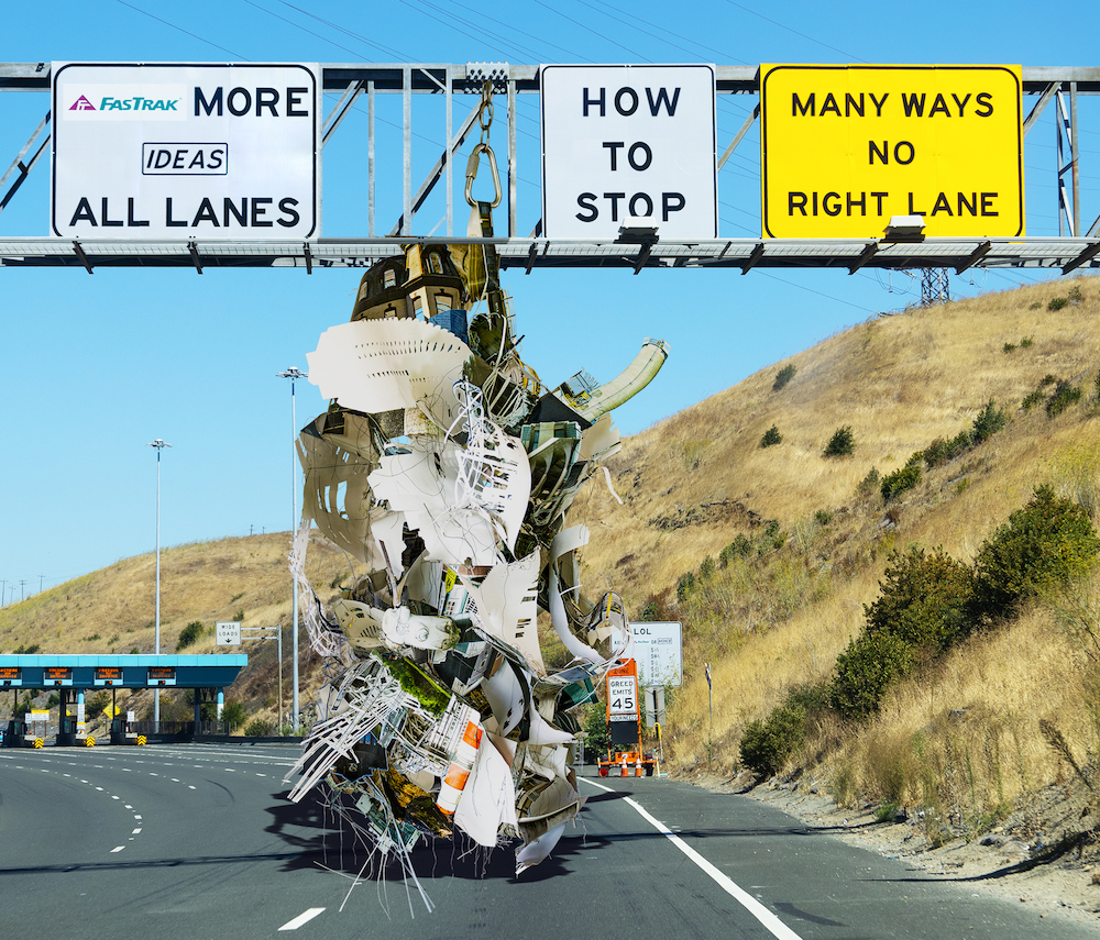 Large object hanging in front of the Carquinez Bridge Toll Plaza with edited signage