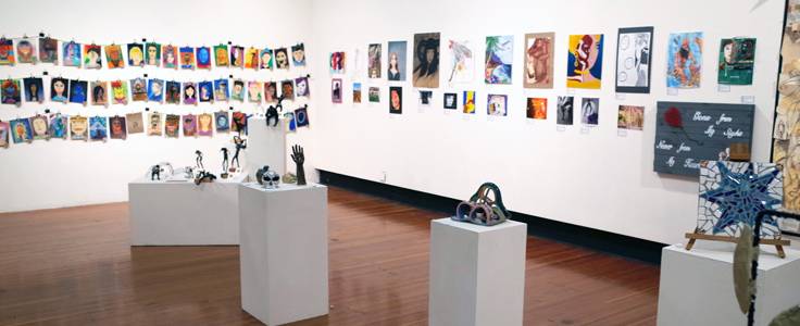 art gallery with pieces on pedestals and the walls