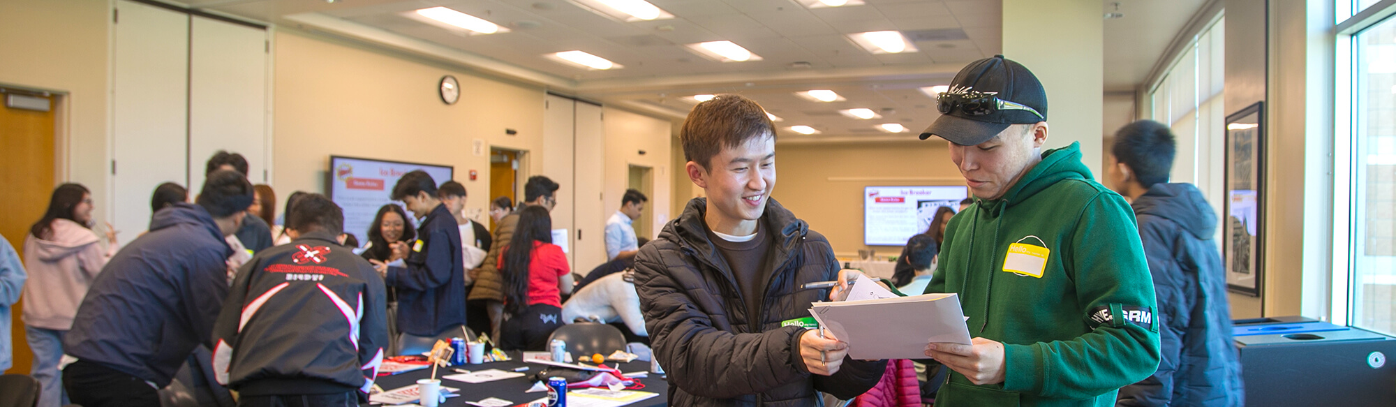 students check out the schedule at orientation event