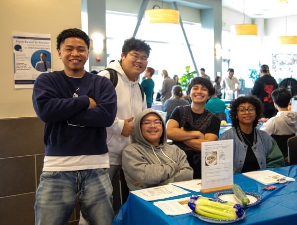 5 students tabling for their club at a college event