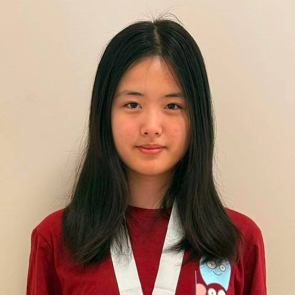 Mengling Wang poses for a photo with an honor society t-shirt and medal
