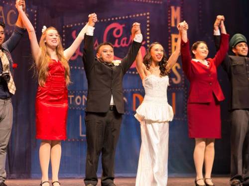 actors in Guys and Dolls the musical bowing to the audience