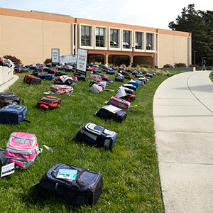 image of backpacks in a grassfield, an ASSC activity