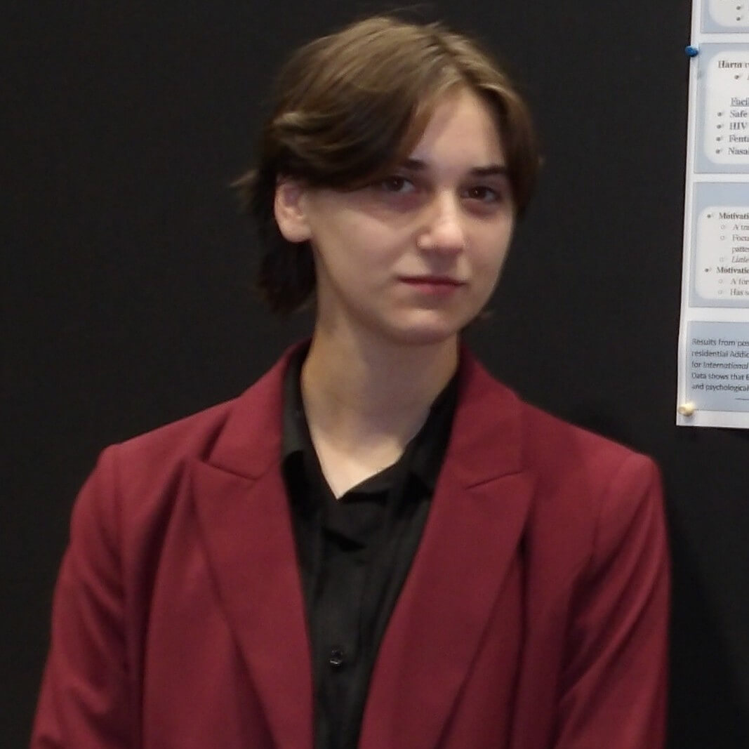 formal photo of president Toby Zakhrov in a red coat an black shirt