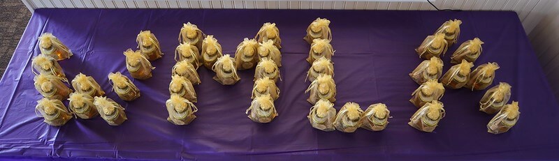 W M L A spelled out in gold candies on a purple tablecloth